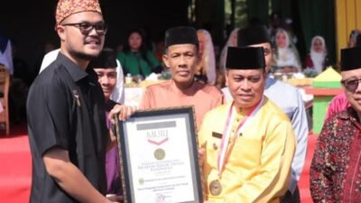 Rayakan HUT Ke 20, Kabupaten Lingga Pecahkan Rekor Muri Pemakaian Tudung Manto